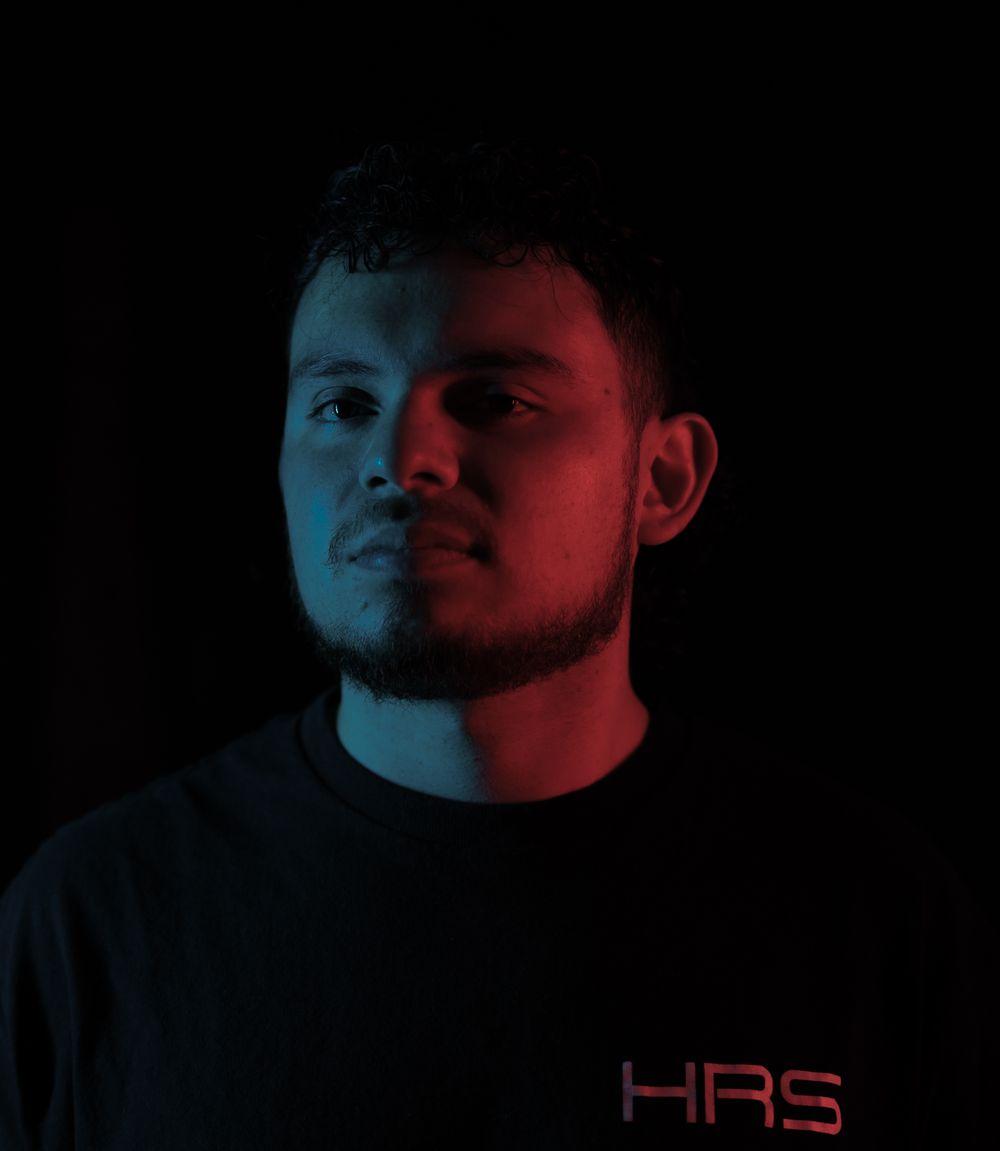Duvan, studio portrait in teal and red light